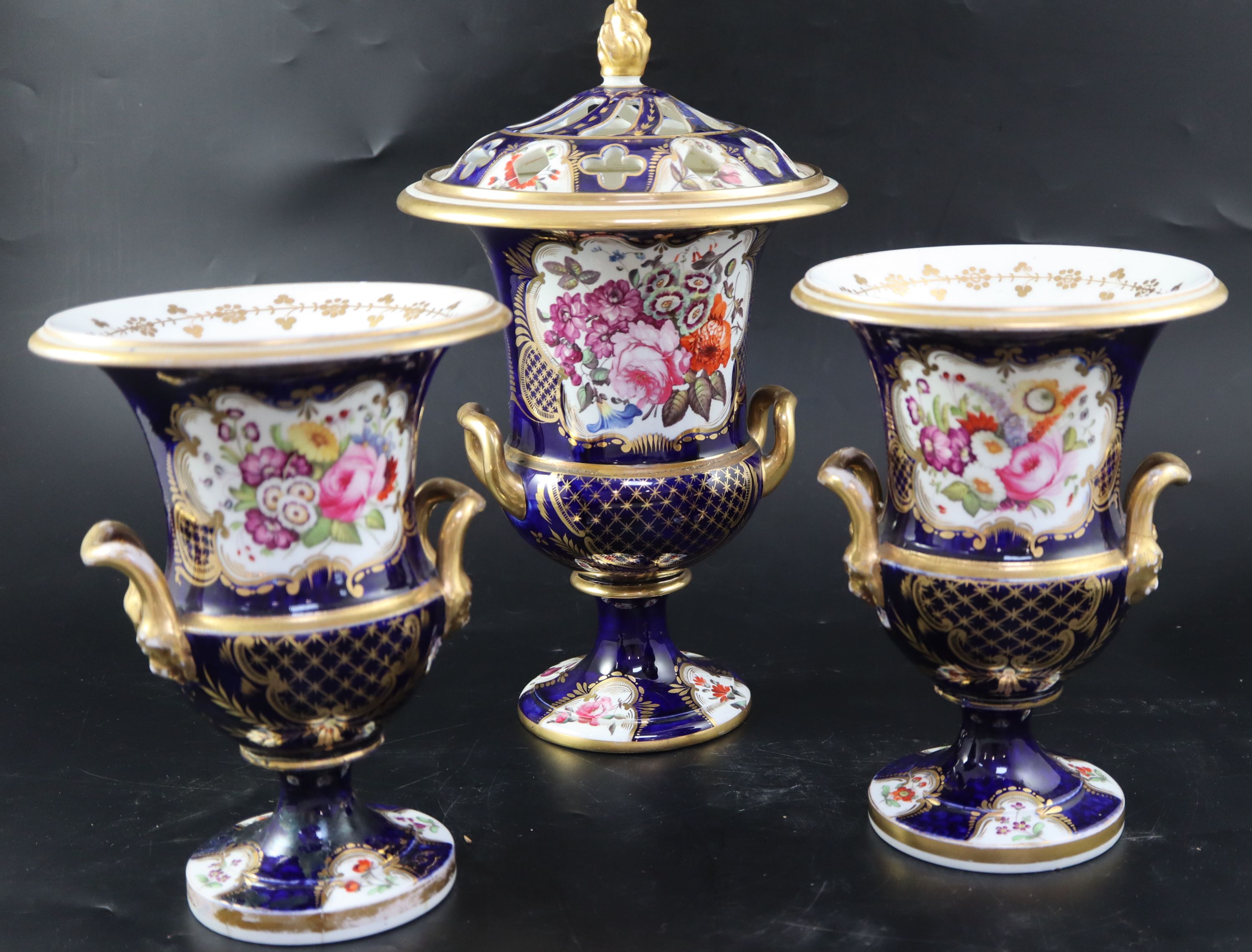 An English porcelain garniture of three vases, c.1830, the central 35cm (a.f.)